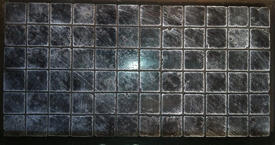 Concrete backsplash panel behind kitchen countertop